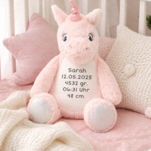 Stofftier Einhorn personalisiert mit Namen Sarah im Kinderbett